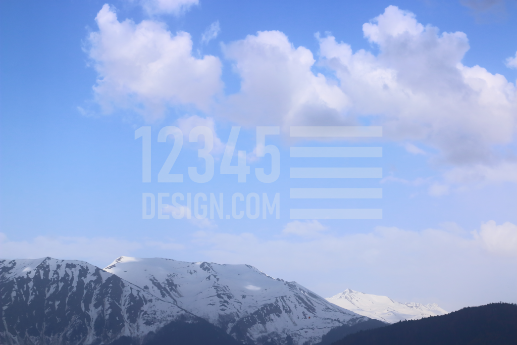 Clouds and snow-capped peaks of the Caucasus Mountains