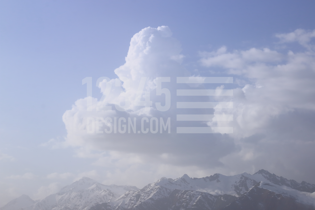 Clouds and snow-capped peaks of the Caucasus Mountains