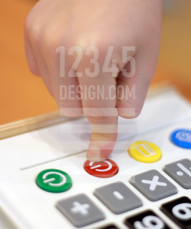 Children's hand presses off button calculator