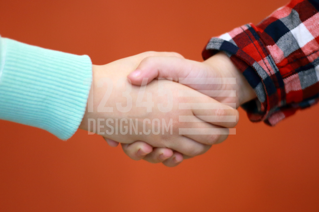 Shaking hands girl and boy